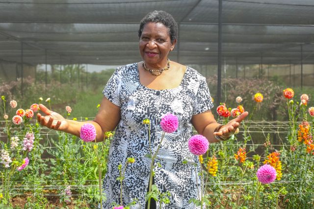 Woman Posing in a Garden Among Flowers