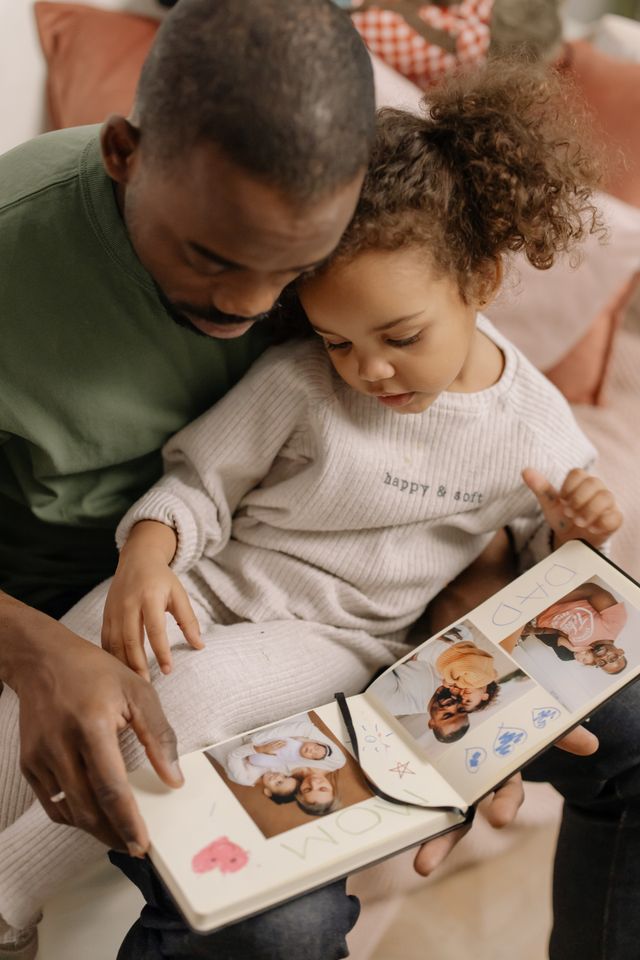 Father and Daughter Looking at Pictures